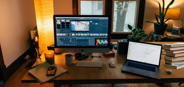 Image of a busy desk with computers and books